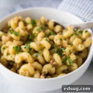 Golden Toasted Walnut Pasta 2 Toasted walnut pasta in a white bowl.
