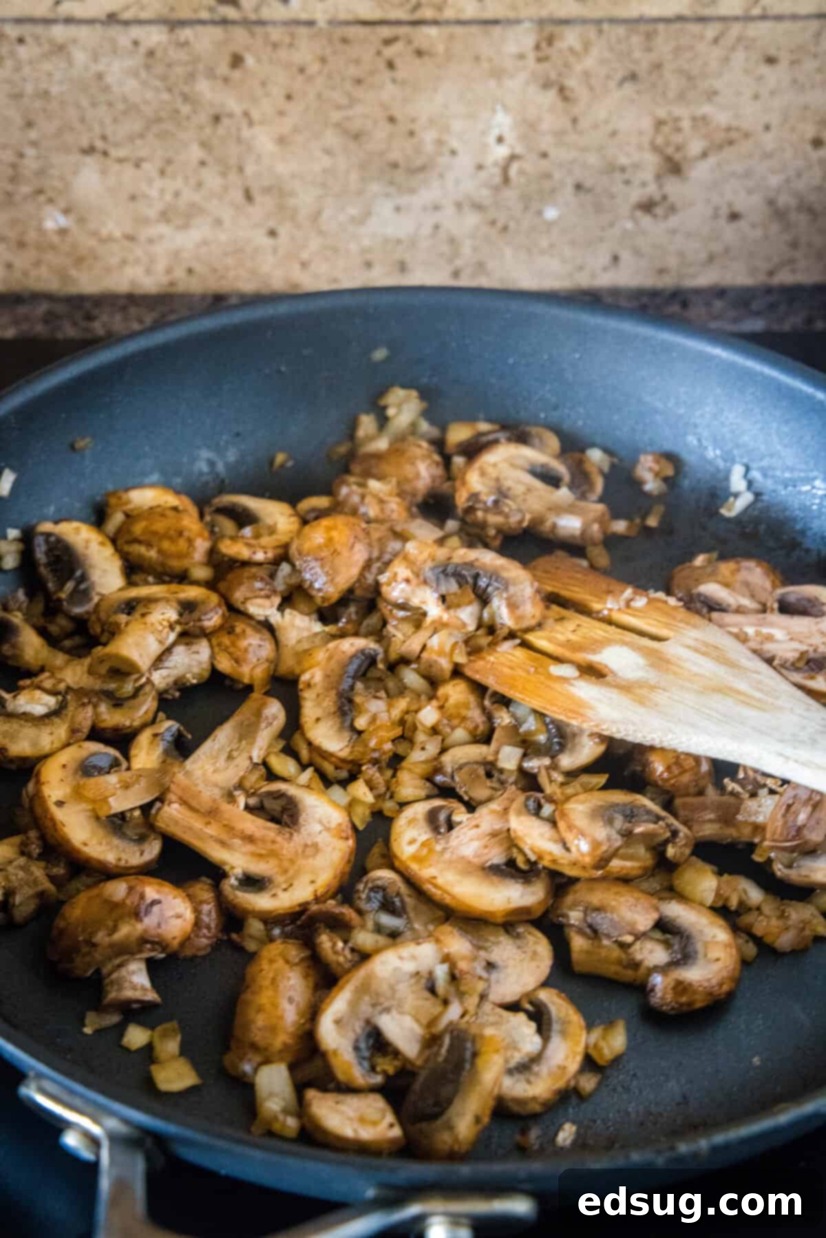 Sausage and Rice Bake 6 Sautéed mushrooms and onions in a skillet, translucent and soft.