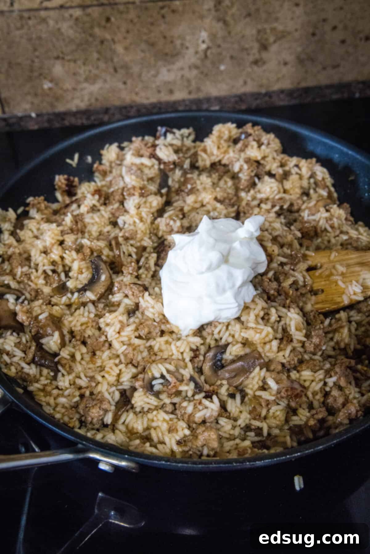 Sausage and Rice Bake 7 Adding light sour cream to the hot sausage and rice mixture.