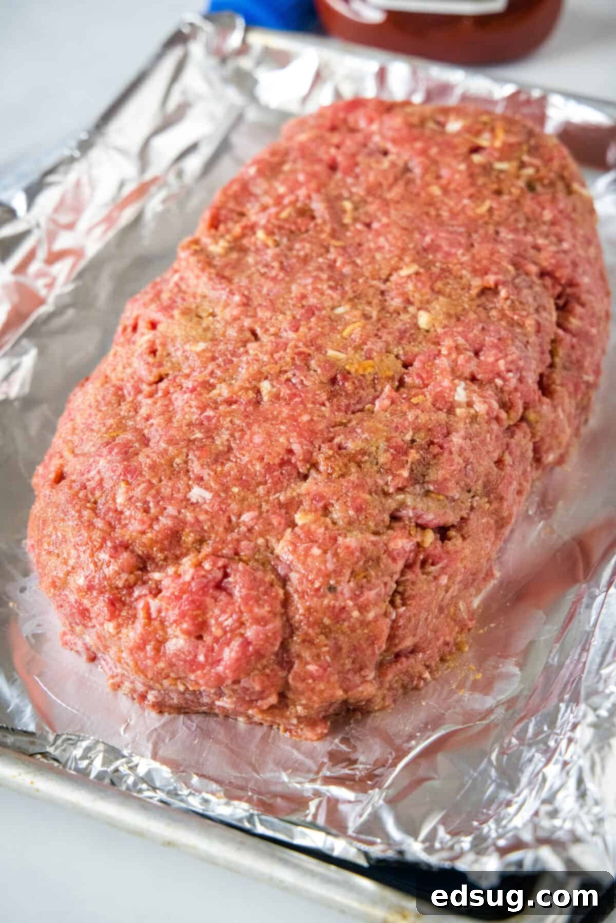 Shaped onion soup meatloaf on a foil-lined baking sheet. Shaped onion soup meatloaf on a foil-lined baking sheet.