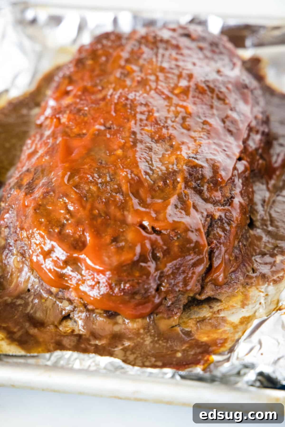 Baked onion soup meatloaf on a foil-lined baking sheet. Baked onion soup meatloaf on a foil-lined baking sheet.
