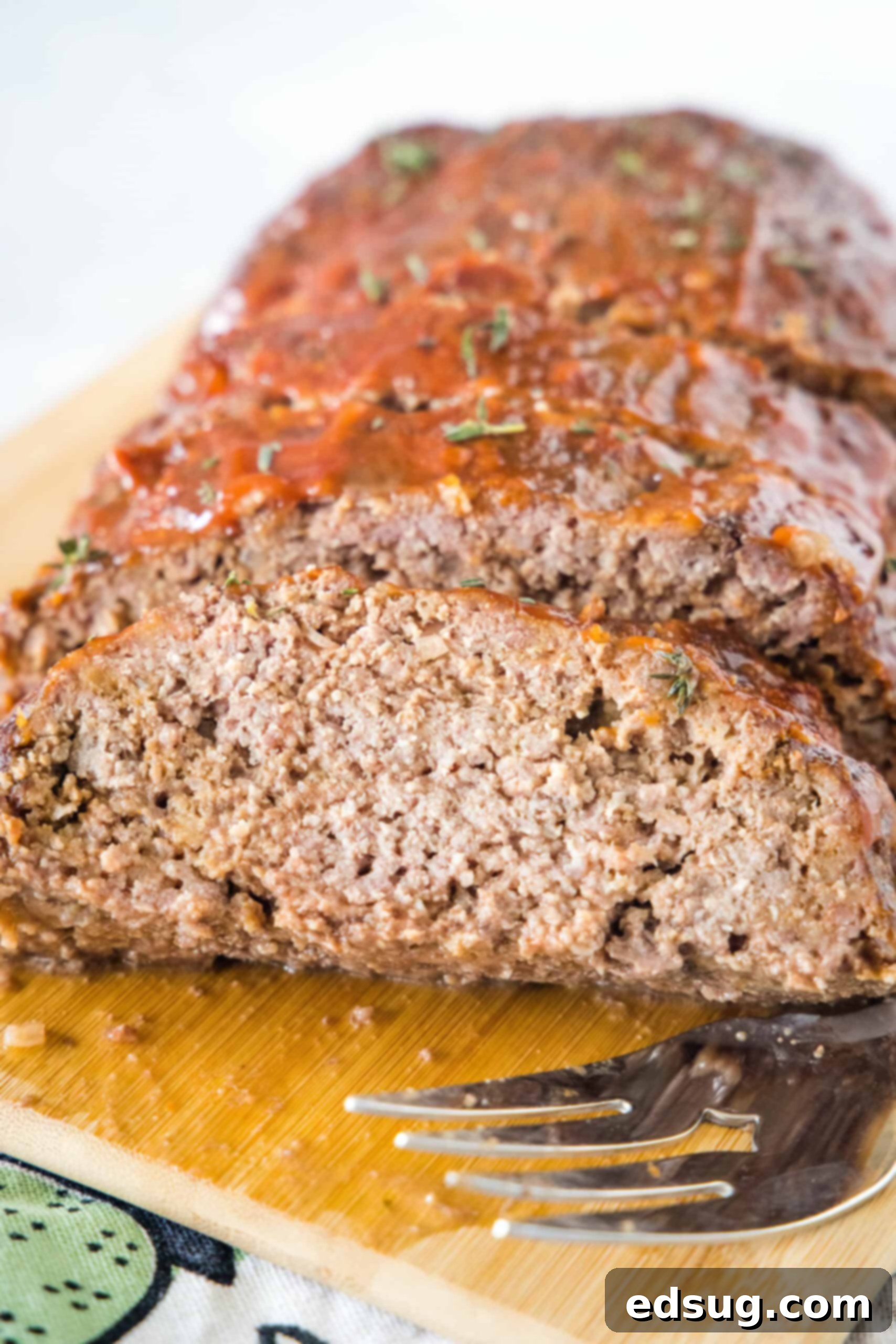 Onion soup meatloaf slices on a wooden cutting board. Onion soup meatloaf slices on a wooden cutting board.