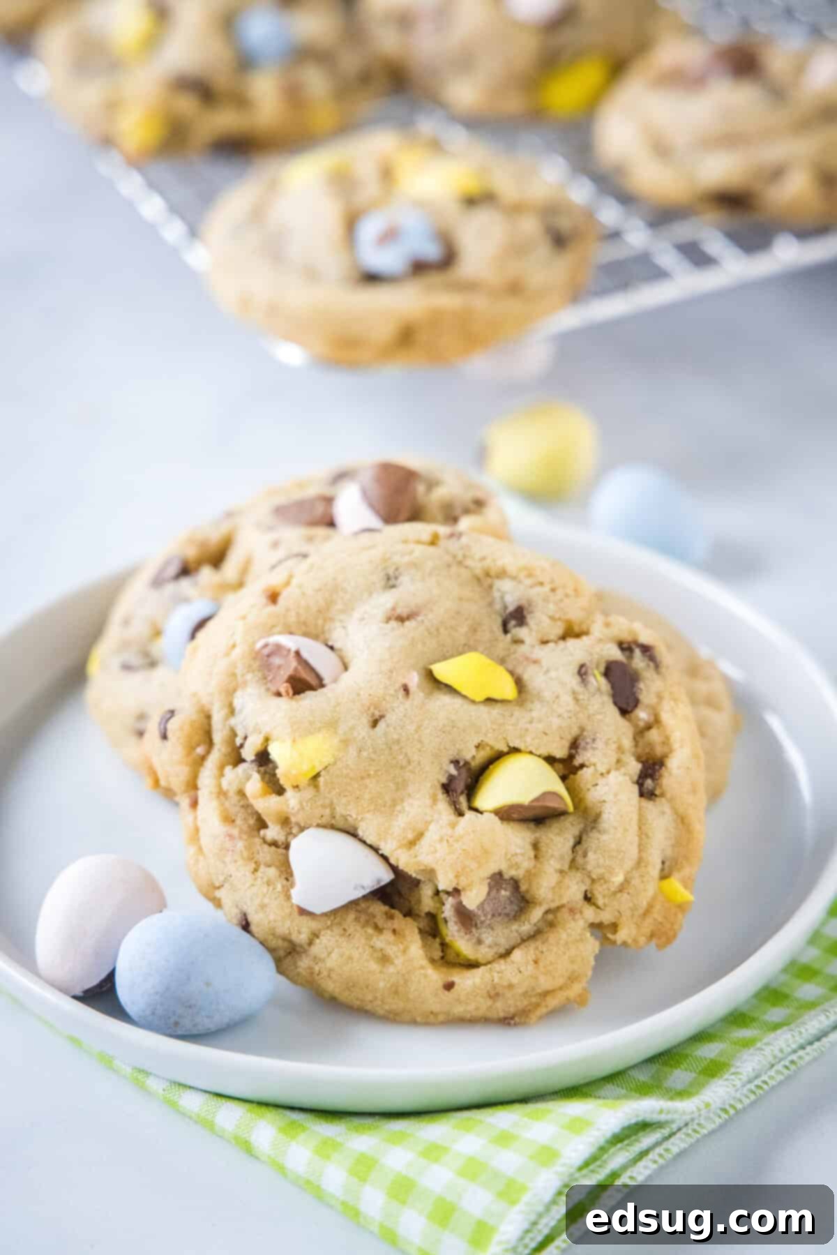 Ultimate Cadbury Mini Egg Cookies 5 chocolate chip cookies with cadbury mini eggs on a baking sheet