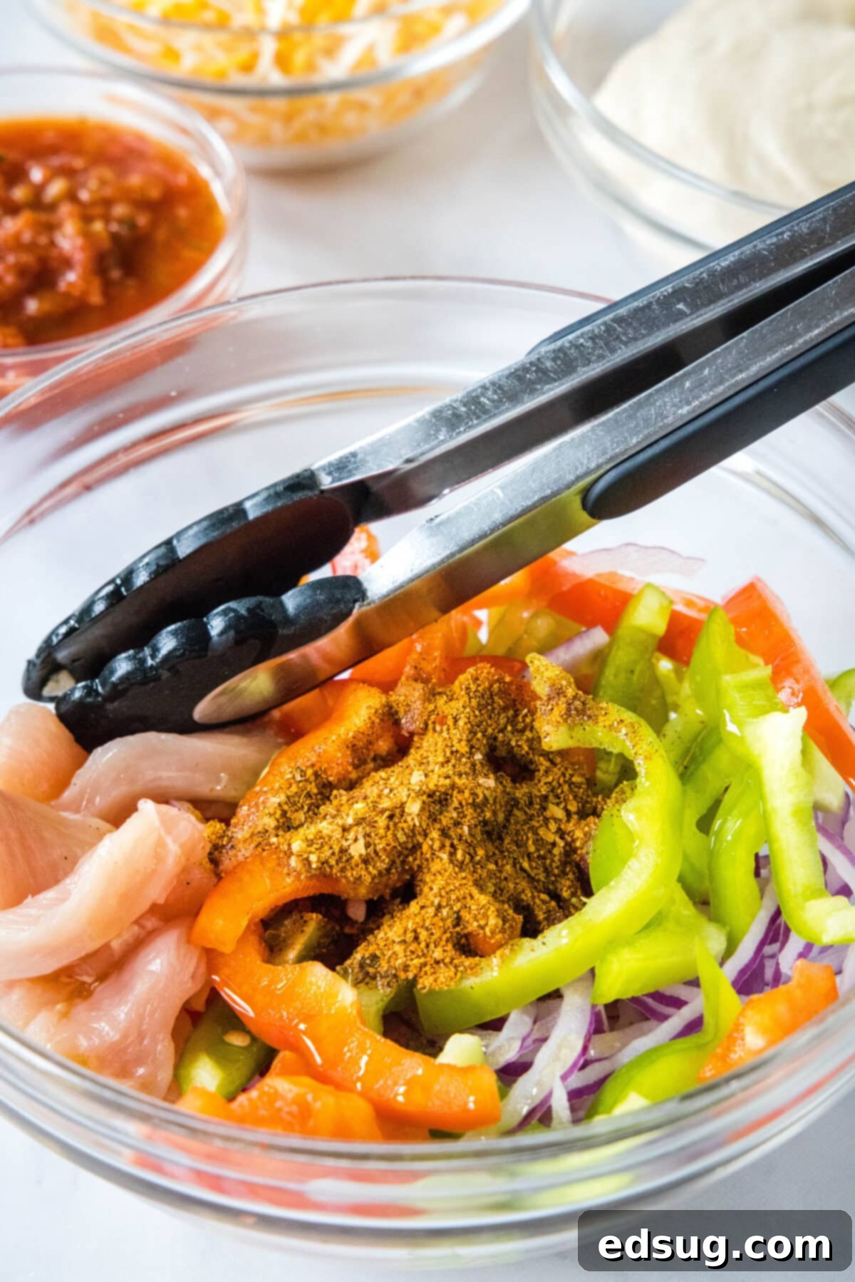 Sizzling Chicken Fajita Bowls 4 chicken fajita ingredients in a mixing bowl
