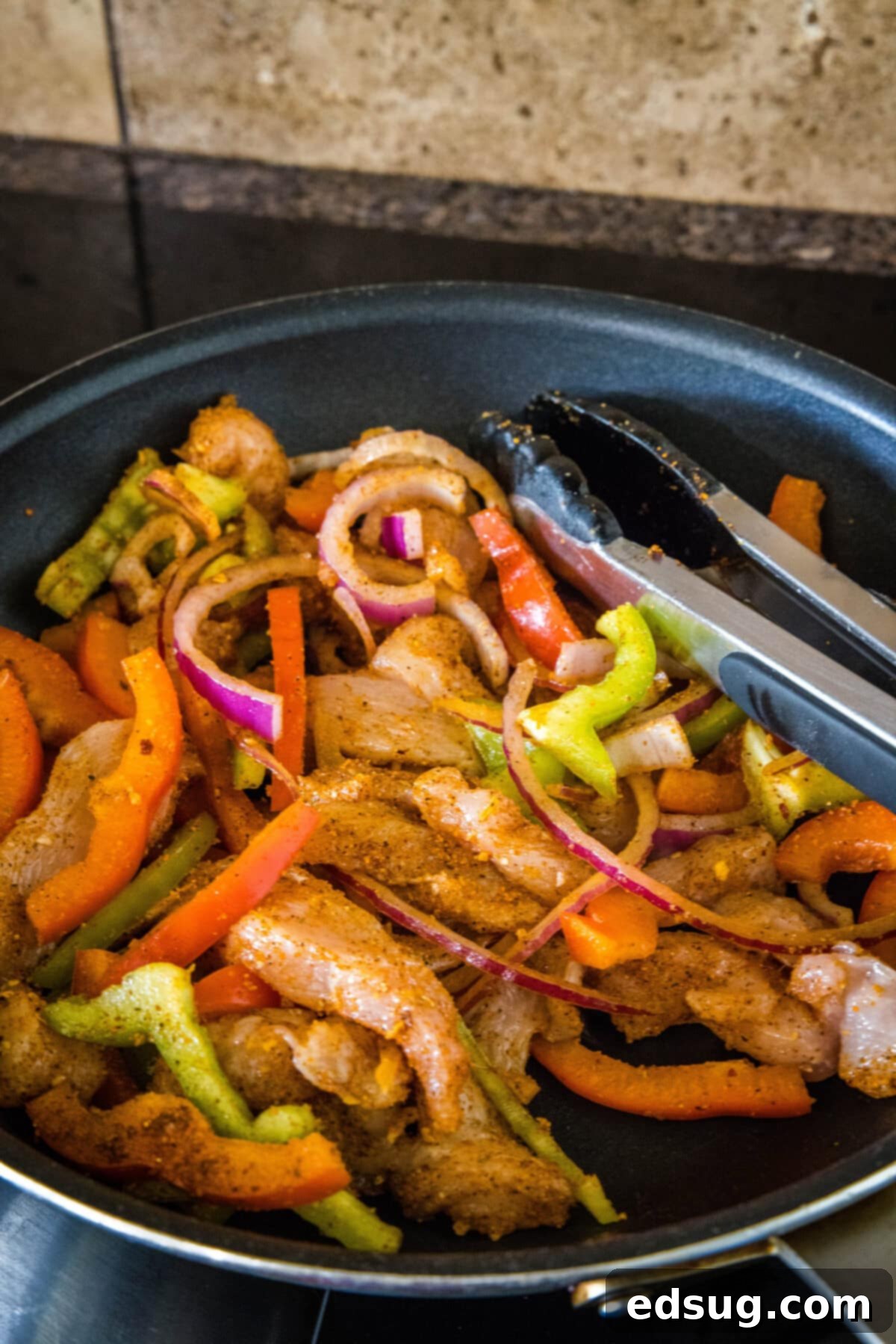 Sizzling Chicken Fajita Bowls 5 cooking chicken fajitas in a skillet