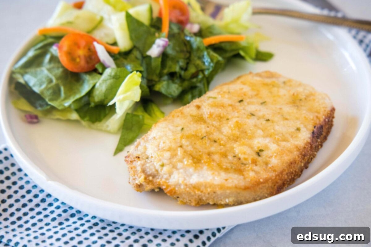 Close-up of a perfectly cooked Air Fryer Boneless Pork Chop, golden brown and juicy, ready to be served.