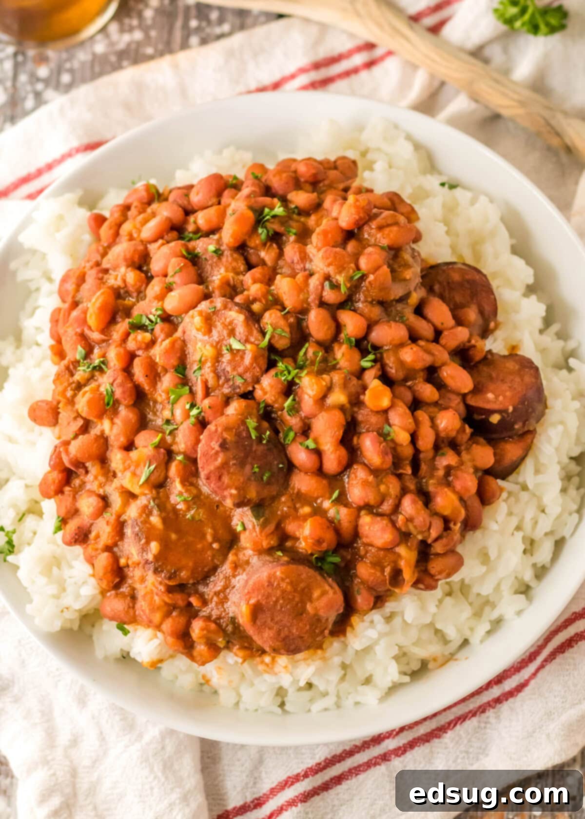 Overhead view of a plate of red beans, sausage, and rice.