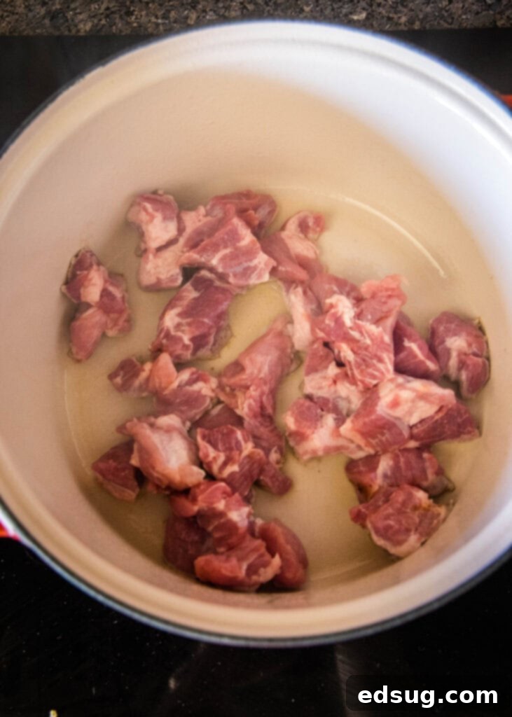 Pork Verde 7 Cubed pork shoulder browning in a large pot, an essential step for flavor.