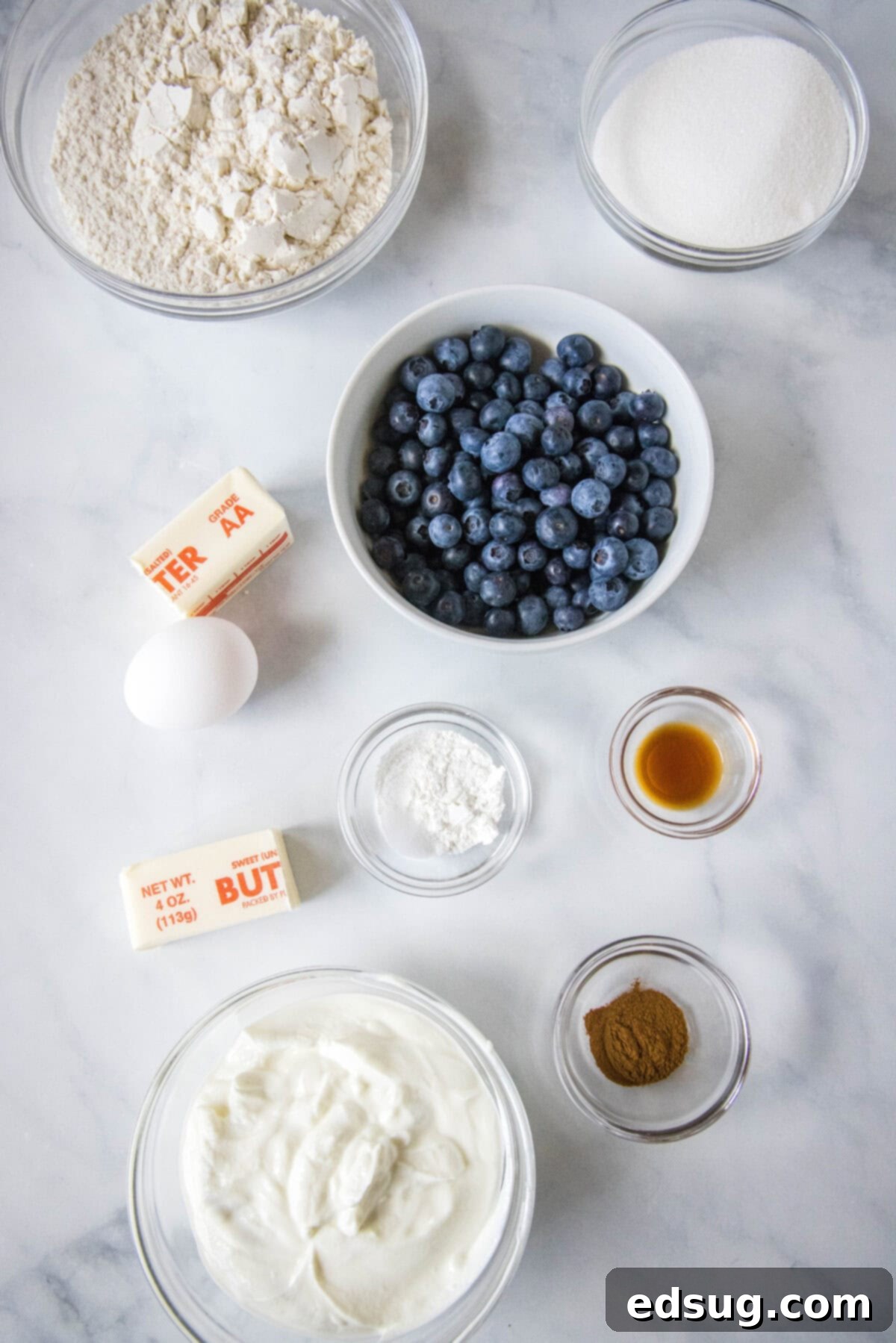 Effortless Blueberry Bliss 3 Key ingredients for easy blueberry muffins laid out on a kitchen counter