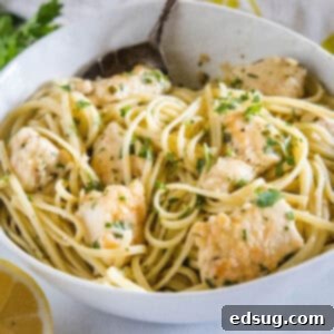 Chicken scampi with spaghetti in a white bowl.