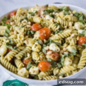 close up pesto pasta salad in a white bowl
