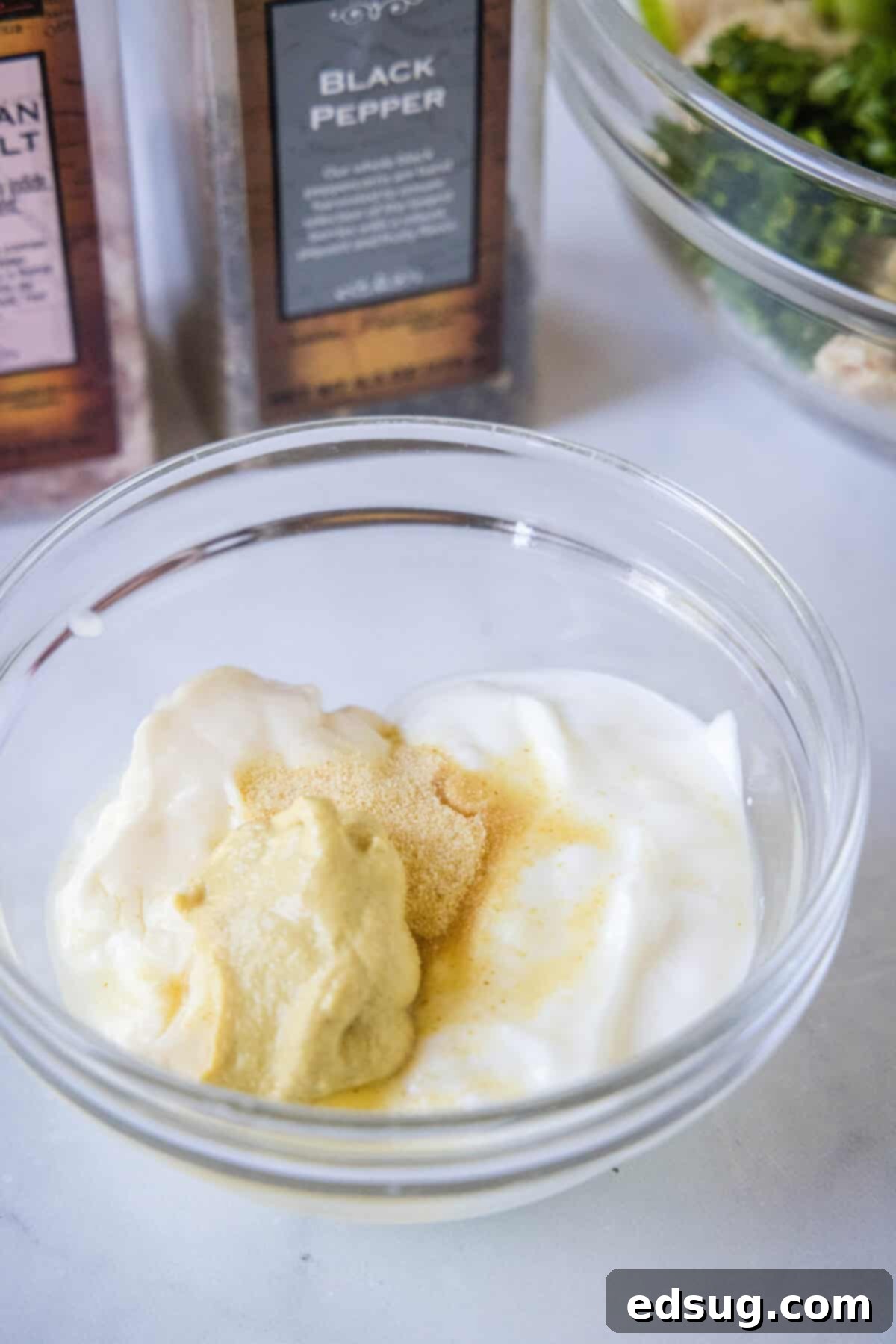 Effortless Rotisserie Chicken Salad 5 All the creamy dressing ingredients—mayo, Greek yogurt, lemon juice, Dijon mustard, and spices—mixed in a small bowl.