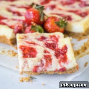 Luscious Strawberry Cheesecake Bars 2 Close up of a strawberry cheesecake bar with fresh strawberries and more bars in the background.