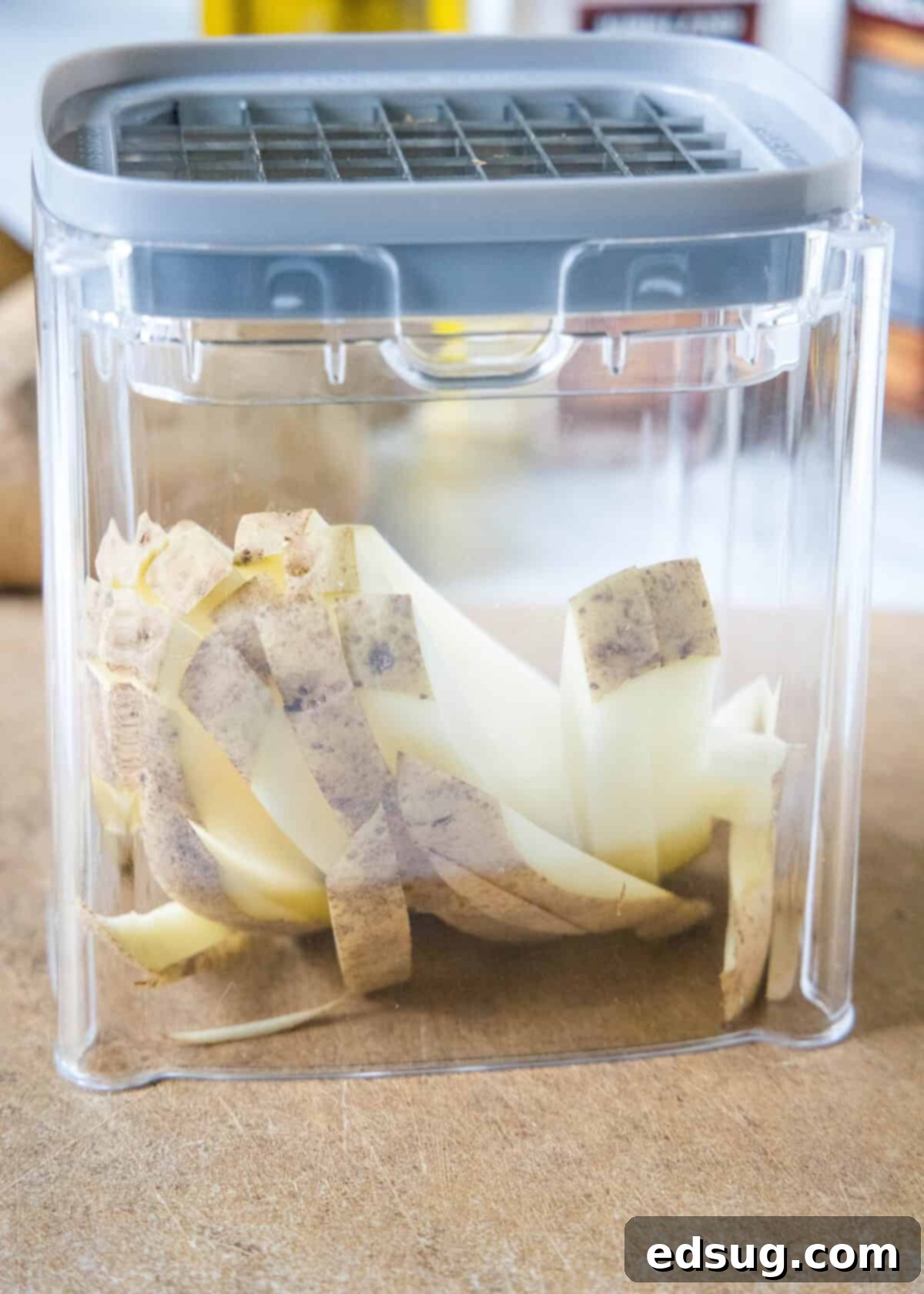 Homemade air fryer French fries are just as crispy as regular fries! Make them in a fraction of the time, with any seasonings you’d like. Potatoes cut into fries inside a potato cutter.