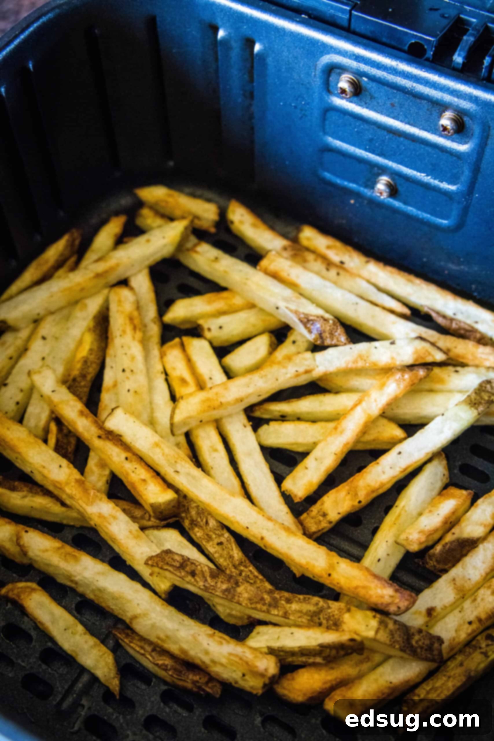 Homemade air fryer French fries are just as crispy as regular fries! Make them in a fraction of the time, with any seasonings you’d like. Crispy homemade French fries inside the air fryer basket.