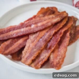 cropped close up cooked turkey bacon on a white plate