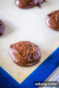 balls of chocolate cookie dough on a baking sheet