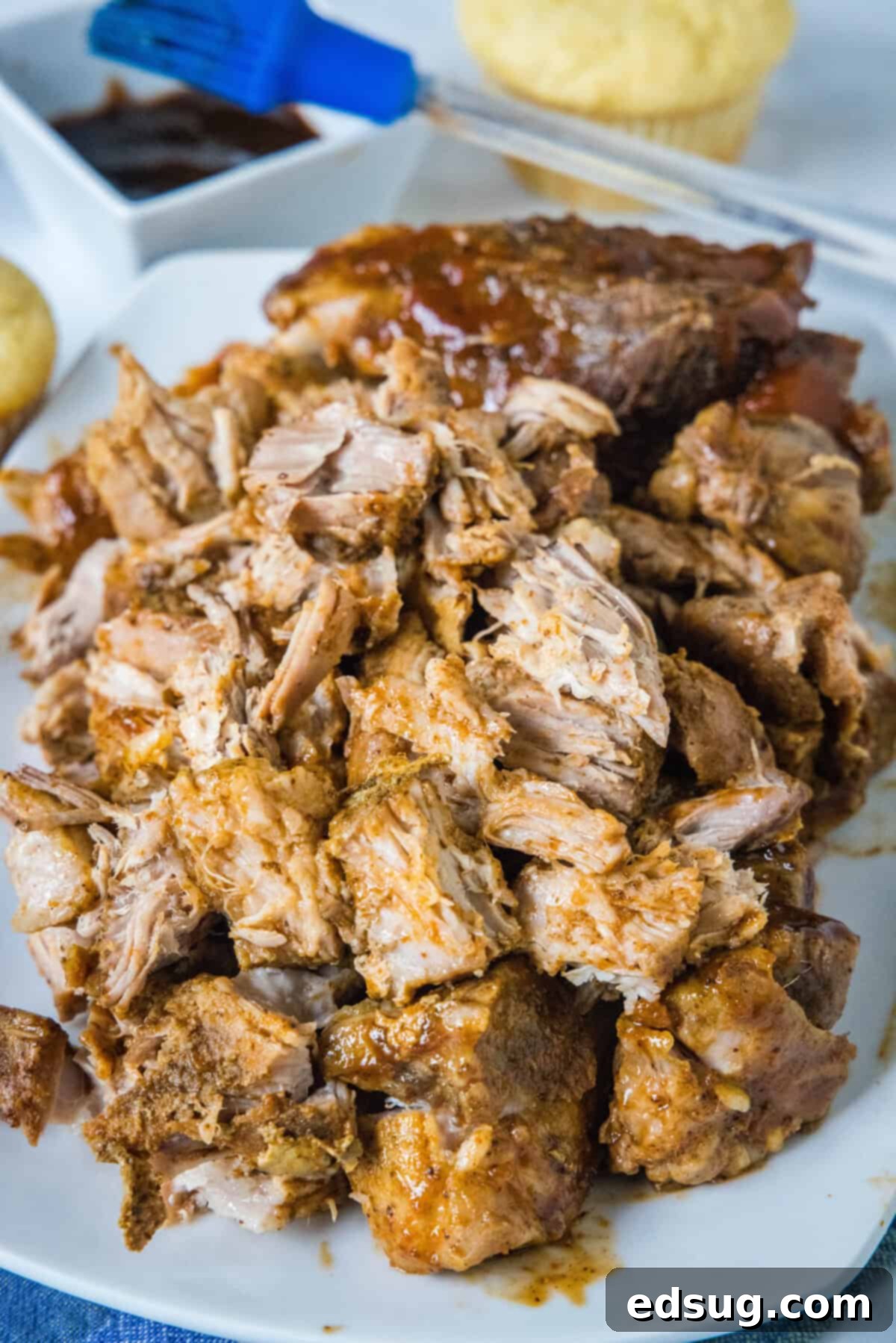 Melt-in-Your-Mouth Slow Cooker Country Ribs 2 shredded country style ribs on a plate