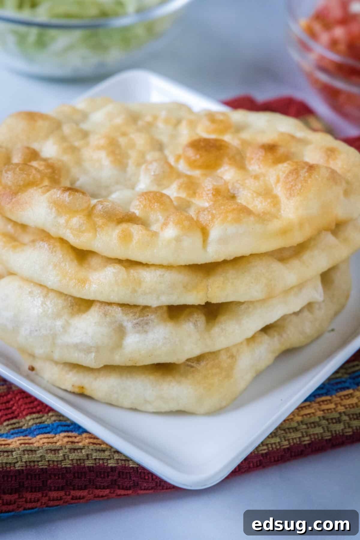 Navajo Fry Bread Tacos 4 A stack of freshly fried Indian fry bread pieces, ready for toppings.