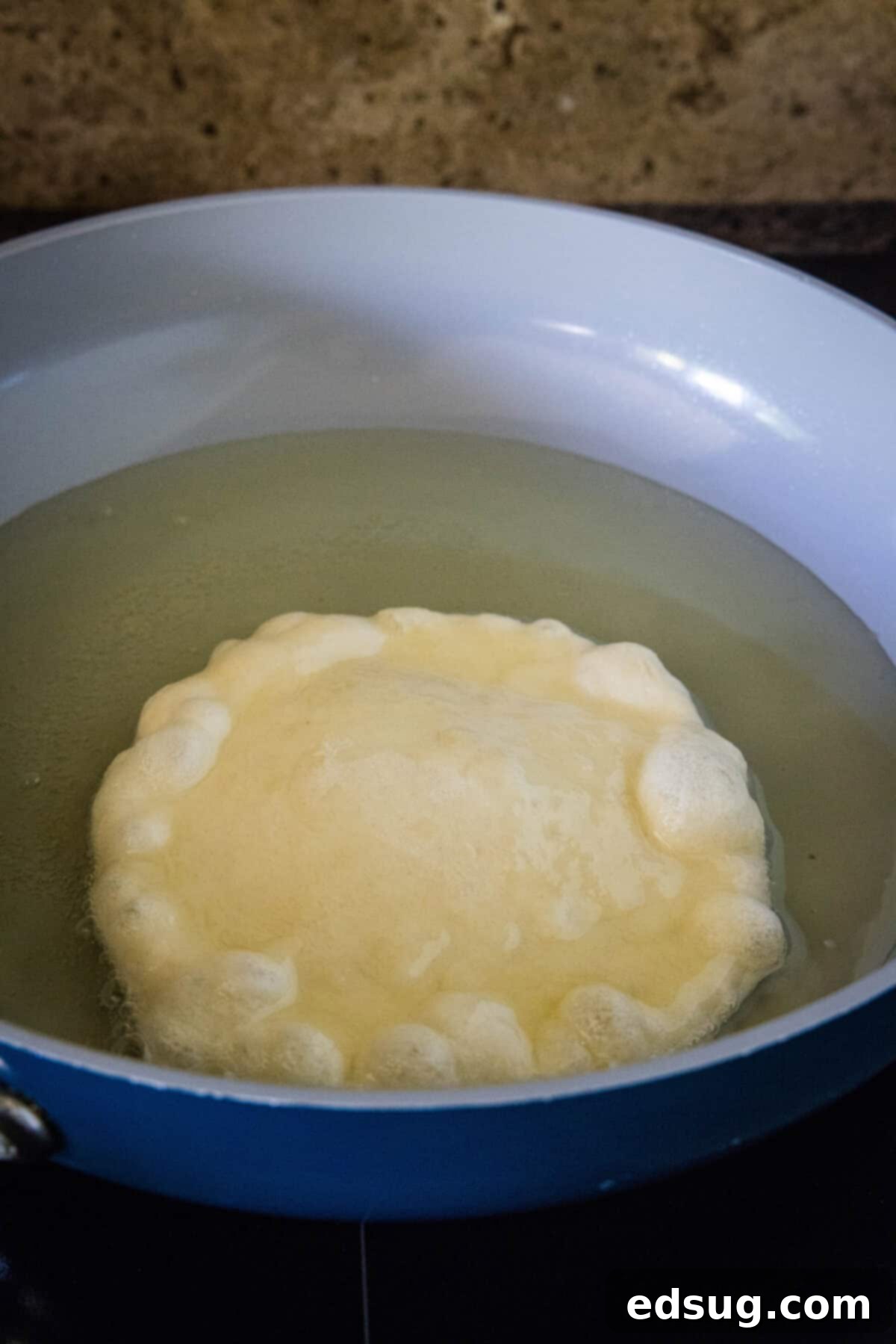 Navajo Fry Bread Tacos 8 Indian fry bread sizzling and puffing up in hot oil in a heavy-bottomed pan.