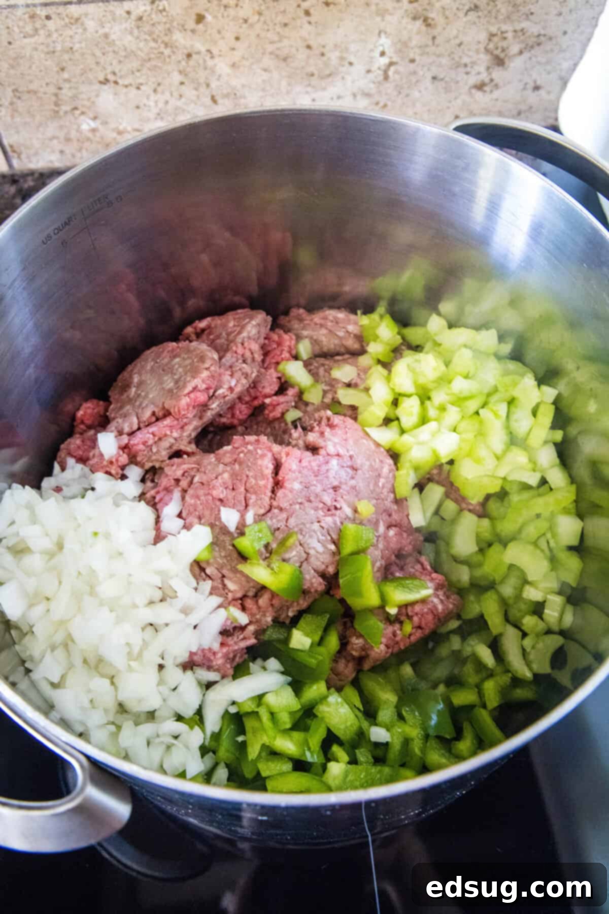 Copycat Wendy's Chili Recipe 5 Ground beef, onions, celery, and bell pepper browning together in a large stockpot, forming the savory base for the chili.