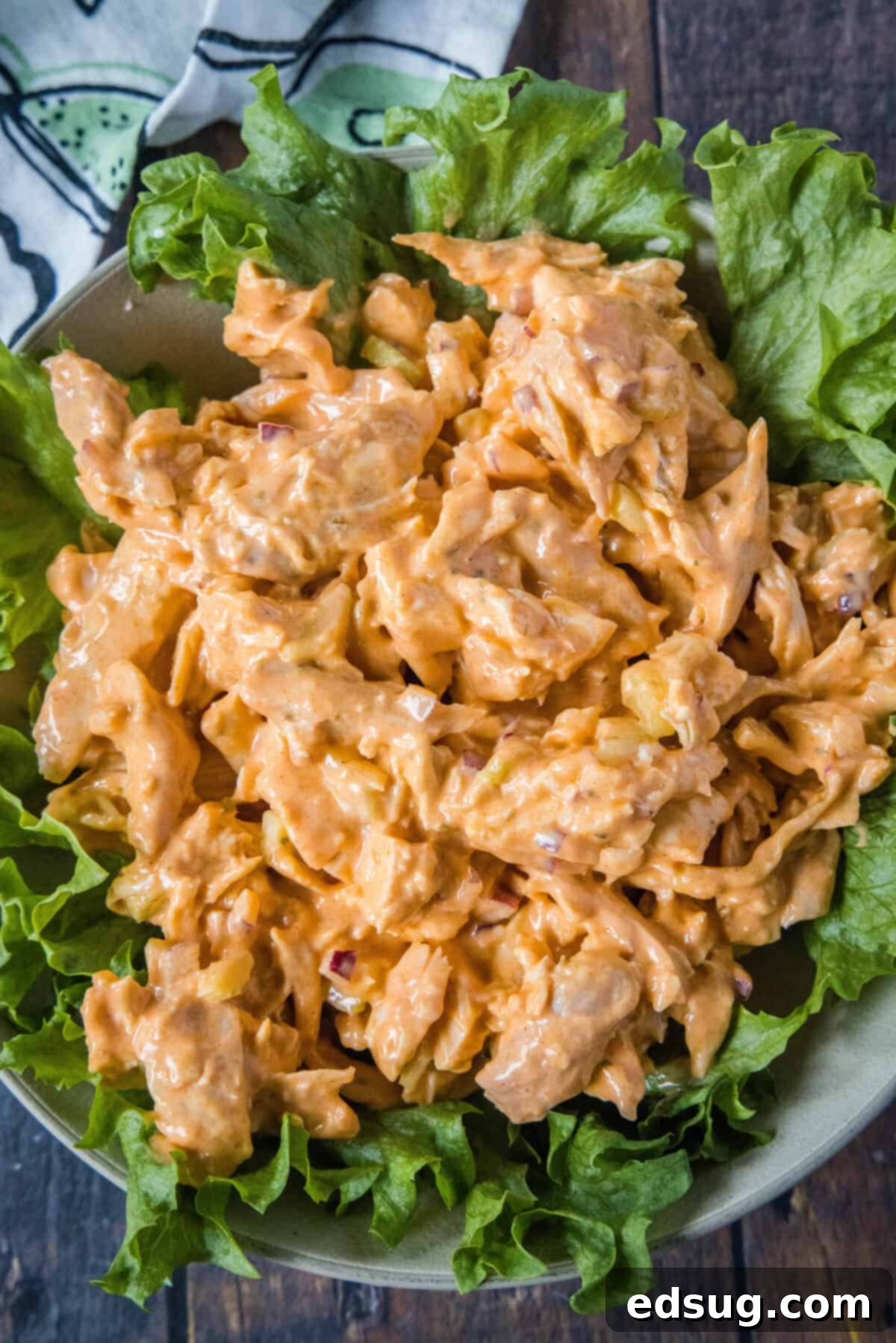 Fiery Buffalo Chicken Salad 7 looking down on a plate with buffalo chicken salad over greens