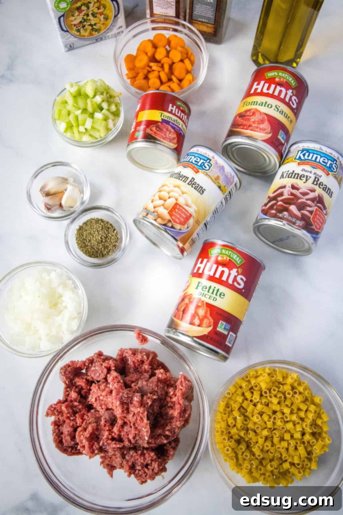 Pasta and Beans 3 Fresh ingredients laid out for homemade Pasta e Fagioli soup, including diced vegetables, canned beans, tomato products, and ditalini pasta.