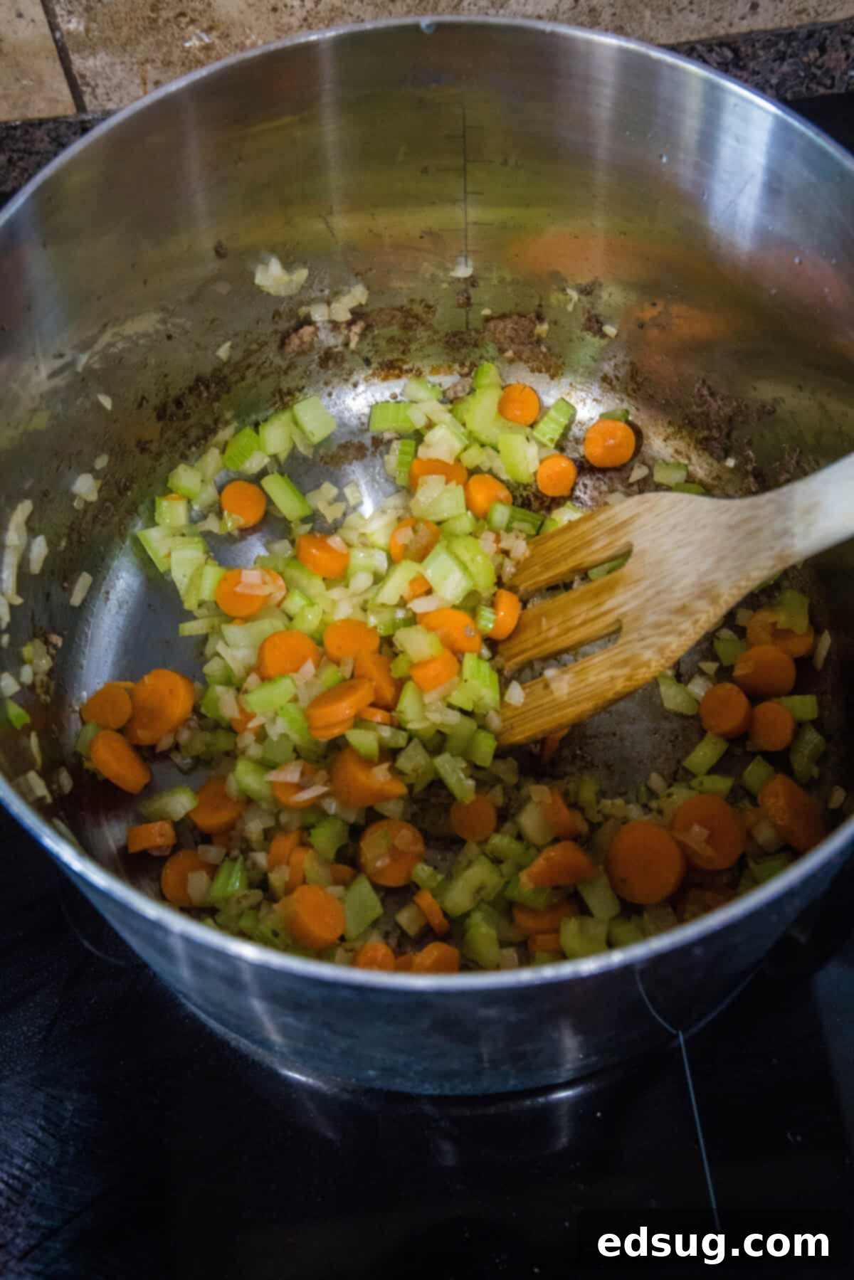 Pasta and Beans 4 Diced carrots, celery, and onions sizzling in olive oil in a large stockpot, forming the aromatic base for the soup.