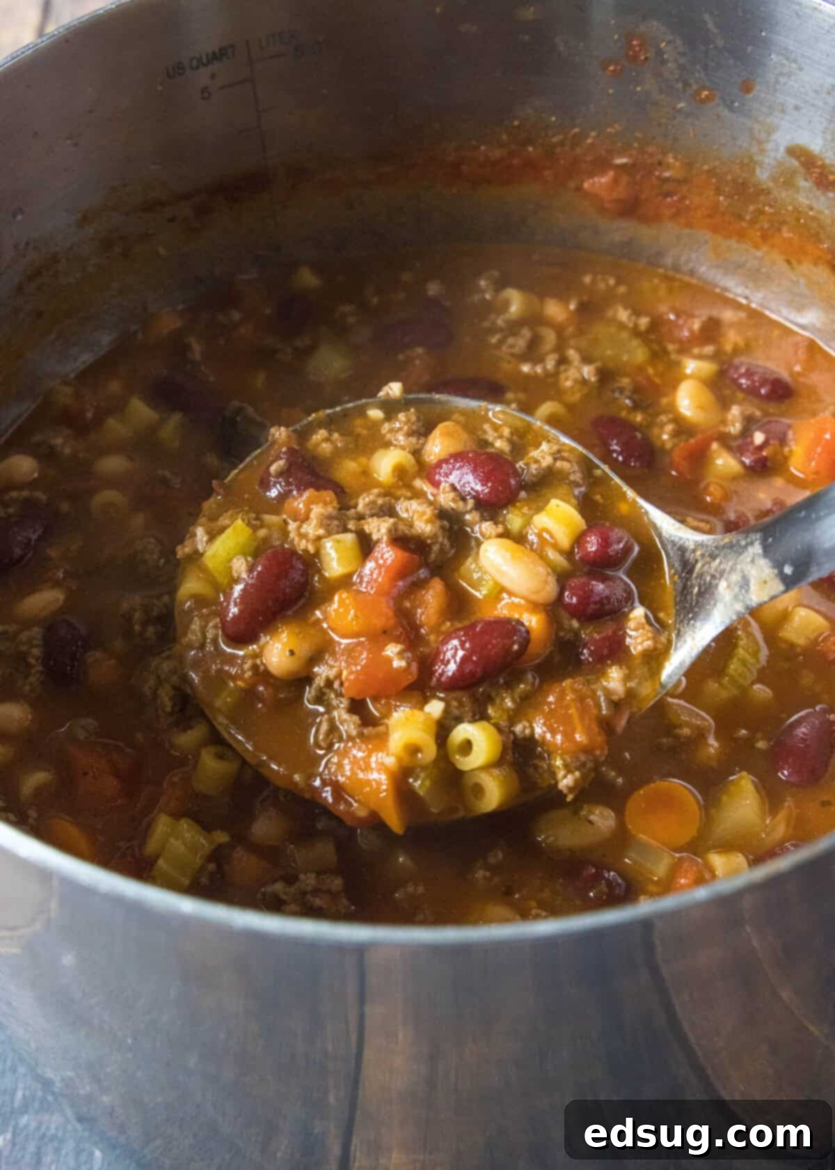 Pasta and Beans 6 A large ladle scooping steaming Pasta e Fagioli soup from a stockpot into a bowl, showing the rich broth, pasta, and beans.