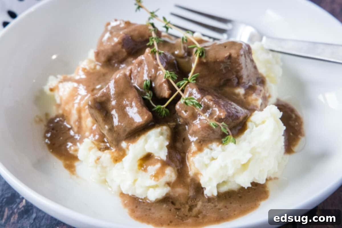 A wide shot of No Peek Beef Tips in gravy served in a casserole dish, ready to be enjoyed.
