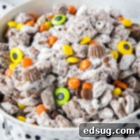 Close up of Halloween Muddy Buddies with orange, purple, and black candy
