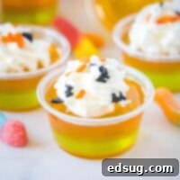 Close up of orange and green layered jello shots in small cups