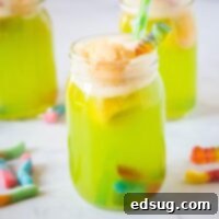 Close up of a vibrant green Witches Brew drink in a glass with dry ice effect