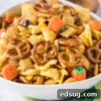 Close up of a bowl of Halloween Party Mix with candy corn and pretzels