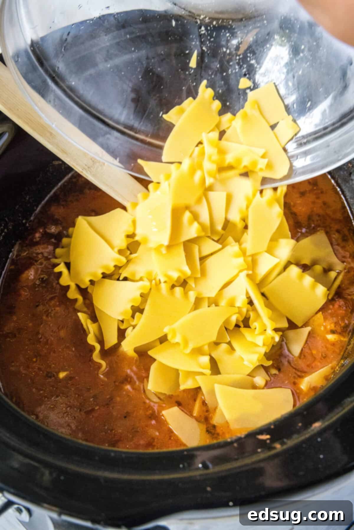 Effortless Lasagna Bowl 5 Slow Cooker Lasagna Soup simmering in a crockpot, showcasing the rich tomato broth and ground meat mixture