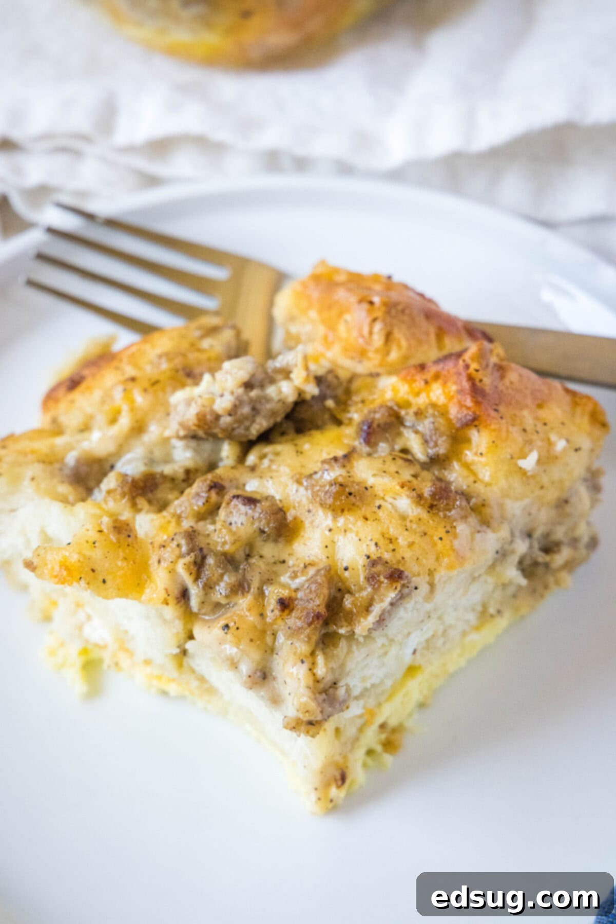 Southern Style Biscuits and Gravy Bake 2 biscuits and gravy casserole on a white plate