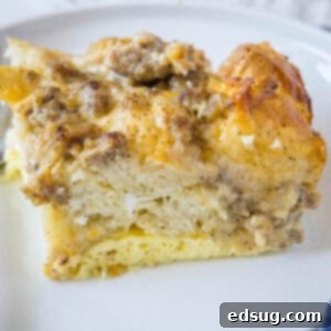 Southern Style Biscuits and Gravy Bake 8 close up slice biscuits and gravy casserole on white plate