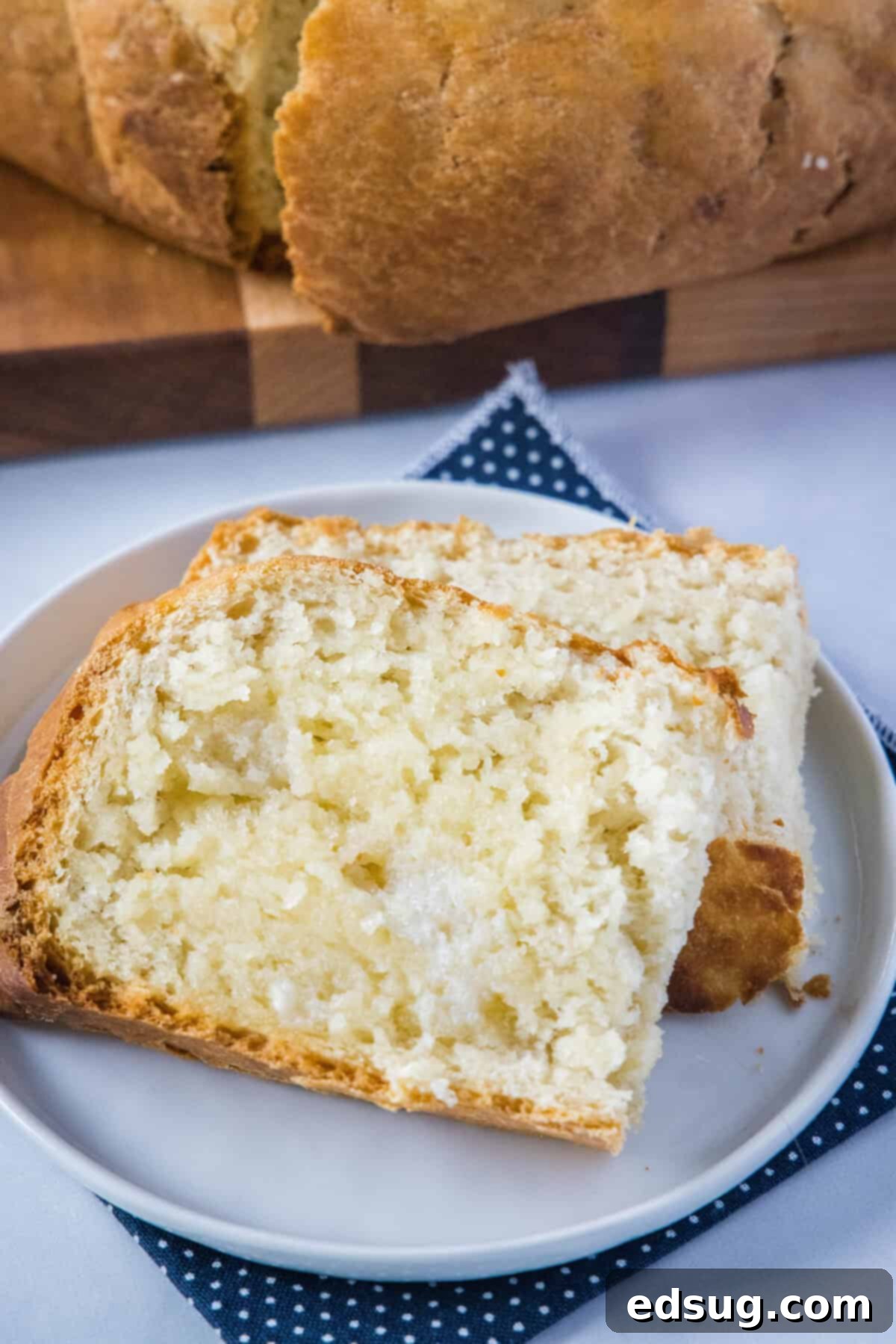 Effortless Slow Cooker Bread 2 Slices of golden slow cooker bread with melted butter, ready to be served.