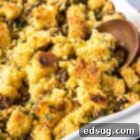 Southern Cornbread Dressing 2 Close up of a wooden spoon in a casserole dish of stuffing