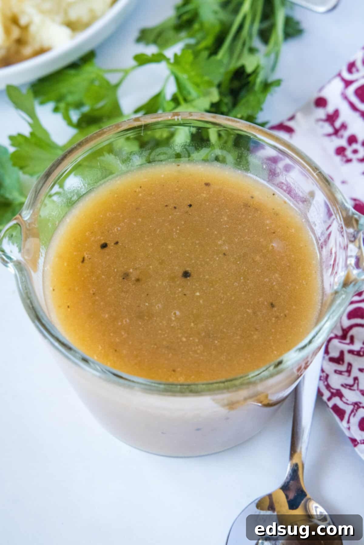 Hearty Pan Gravy 6 looking down on brown gravy in a measuring cup