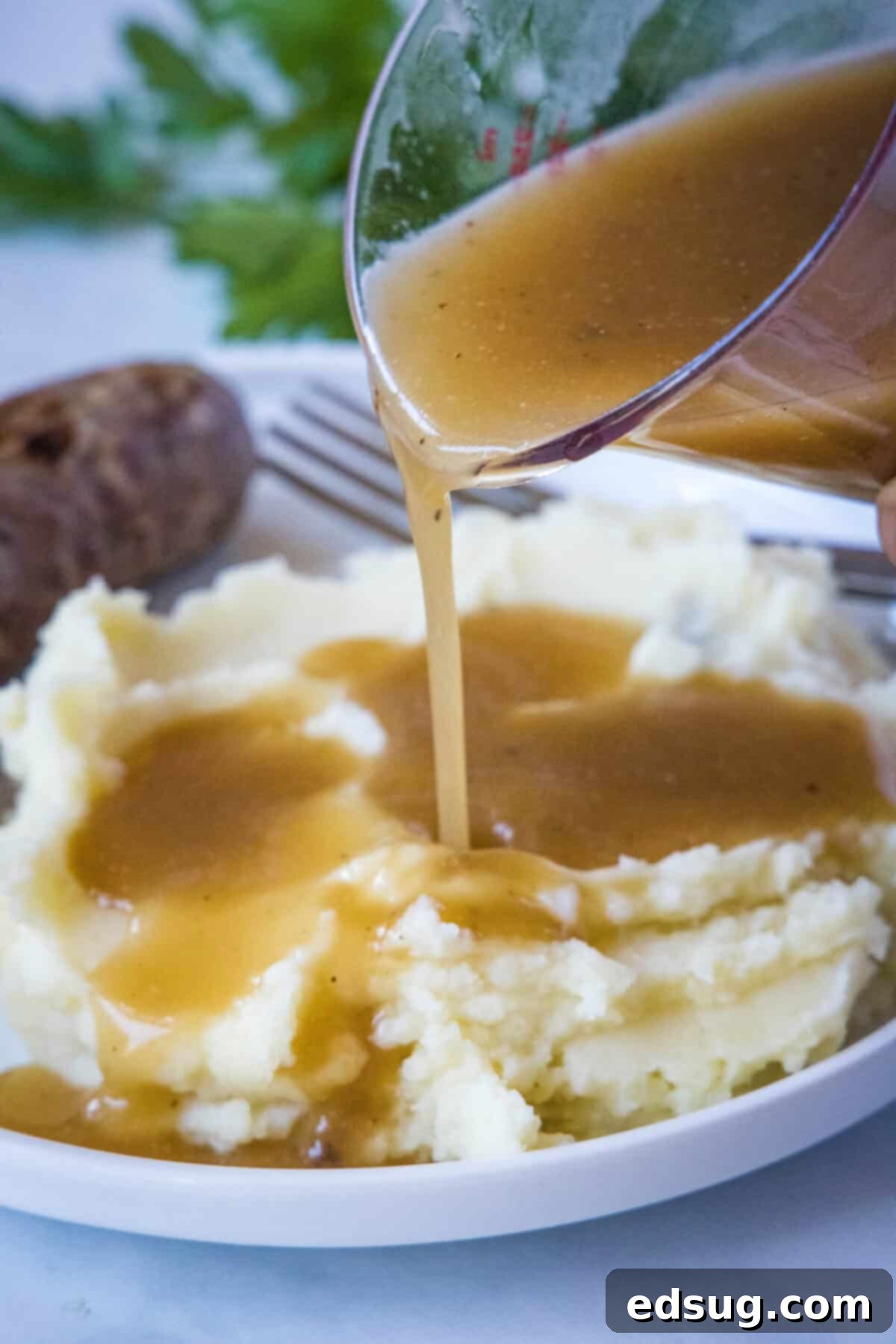 Hearty Pan Gravy 7 pouring gravy onto potatoes
