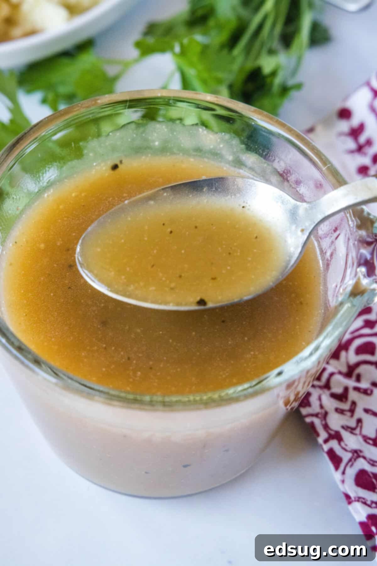 Hearty Pan Gravy 8 spooning brown gravy out of a up