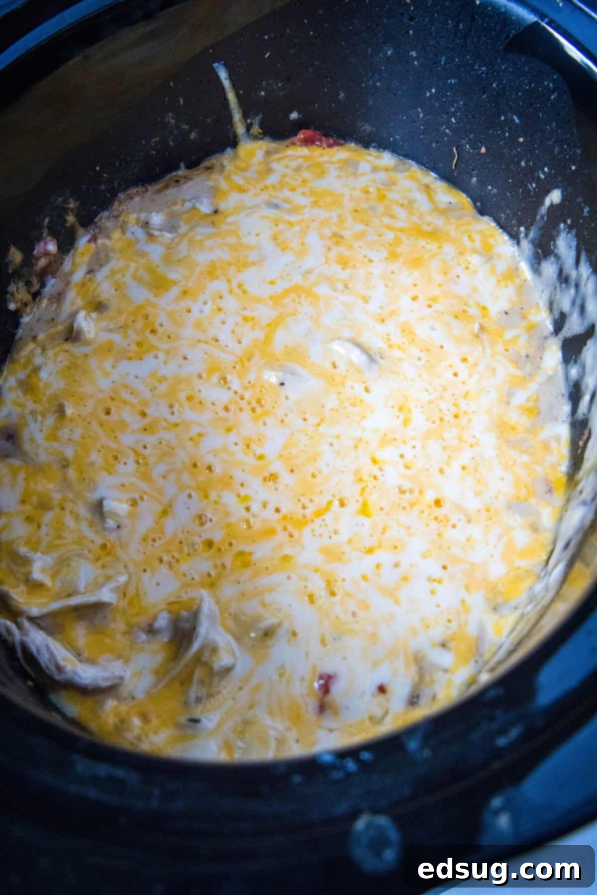 Effortless Slow Cooker Chicken Spaghetti 6 melted cheese and shredded chicken in crockpot