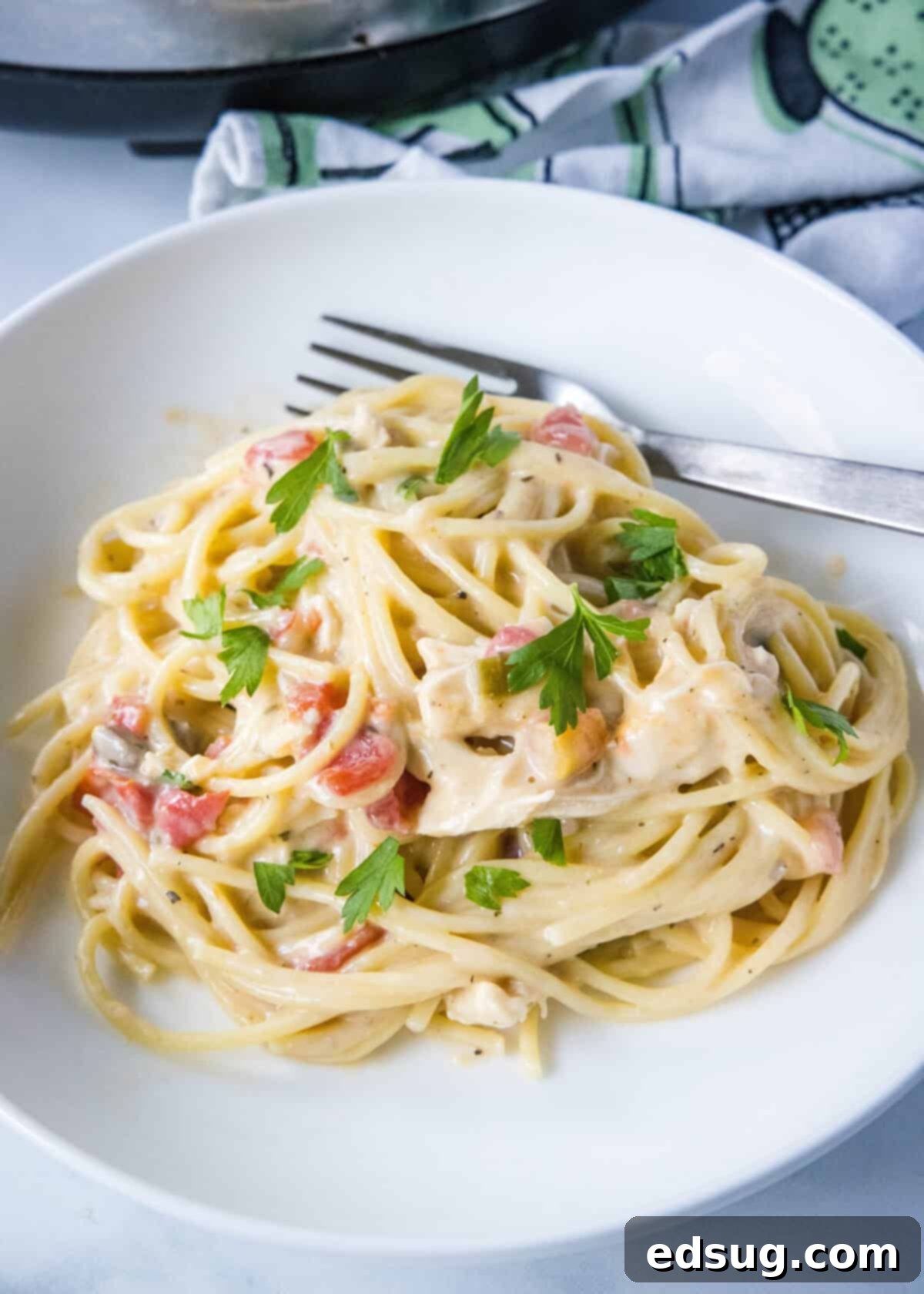 Effortless Slow Cooker Chicken Spaghetti 8 crockpot chicken spaghetti on a white plate