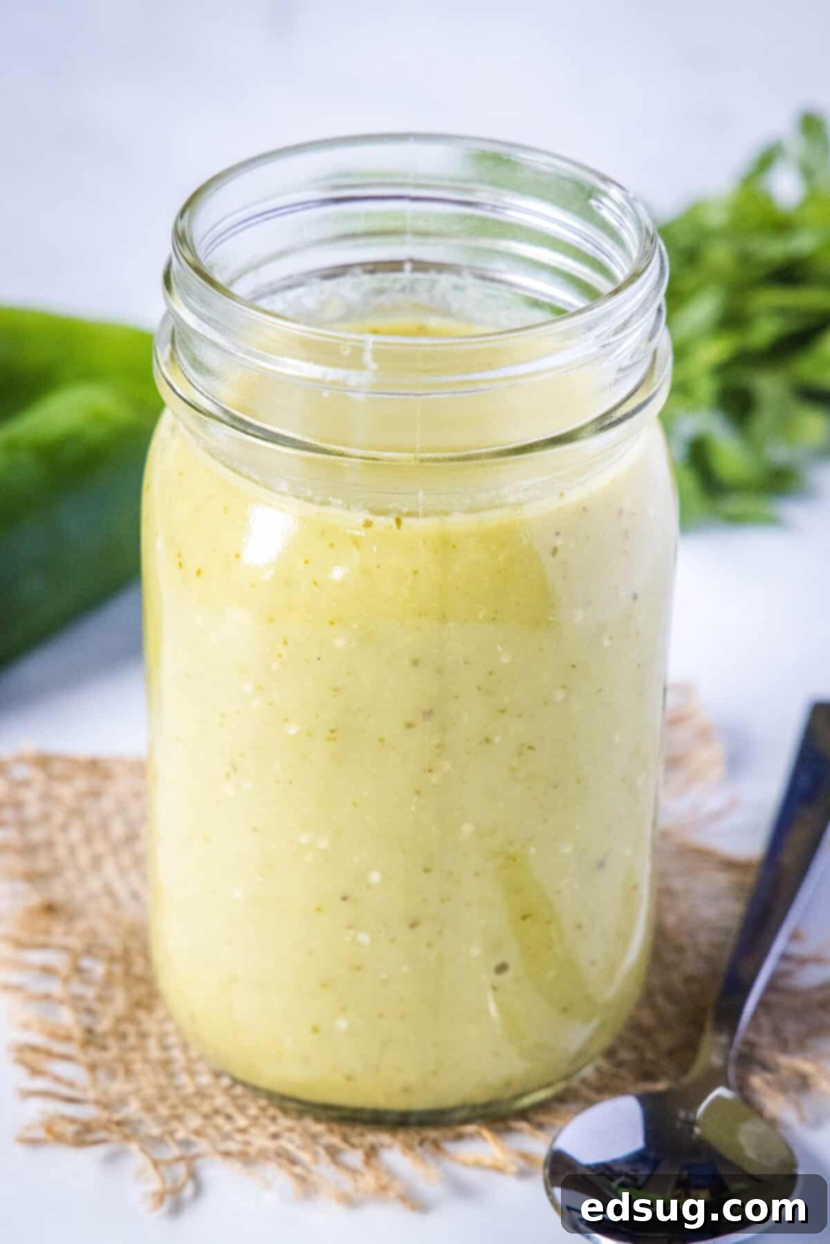 Authentic Green Enchilada Sauce 7 A clear glass jar filled with freshly made, vibrant green enchilada sauce, ready for storage or immediate use.