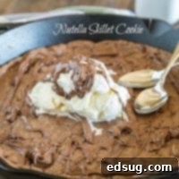 The Ultimate Nutella Skillet Cookie 3 Nutella Skillet Cookie - a nutella based chocolate chip cookie baked into a cast iron skillet, with a layer of nutella in the middle!