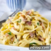 Fiesta Carbonara 7 A close up of pasta carbonara with corn and chilies on a plate