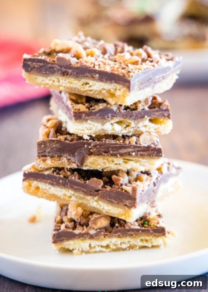 Addictive Chocolate Saltine Christmas Crack 2 saltine toffee stacked on a white plate