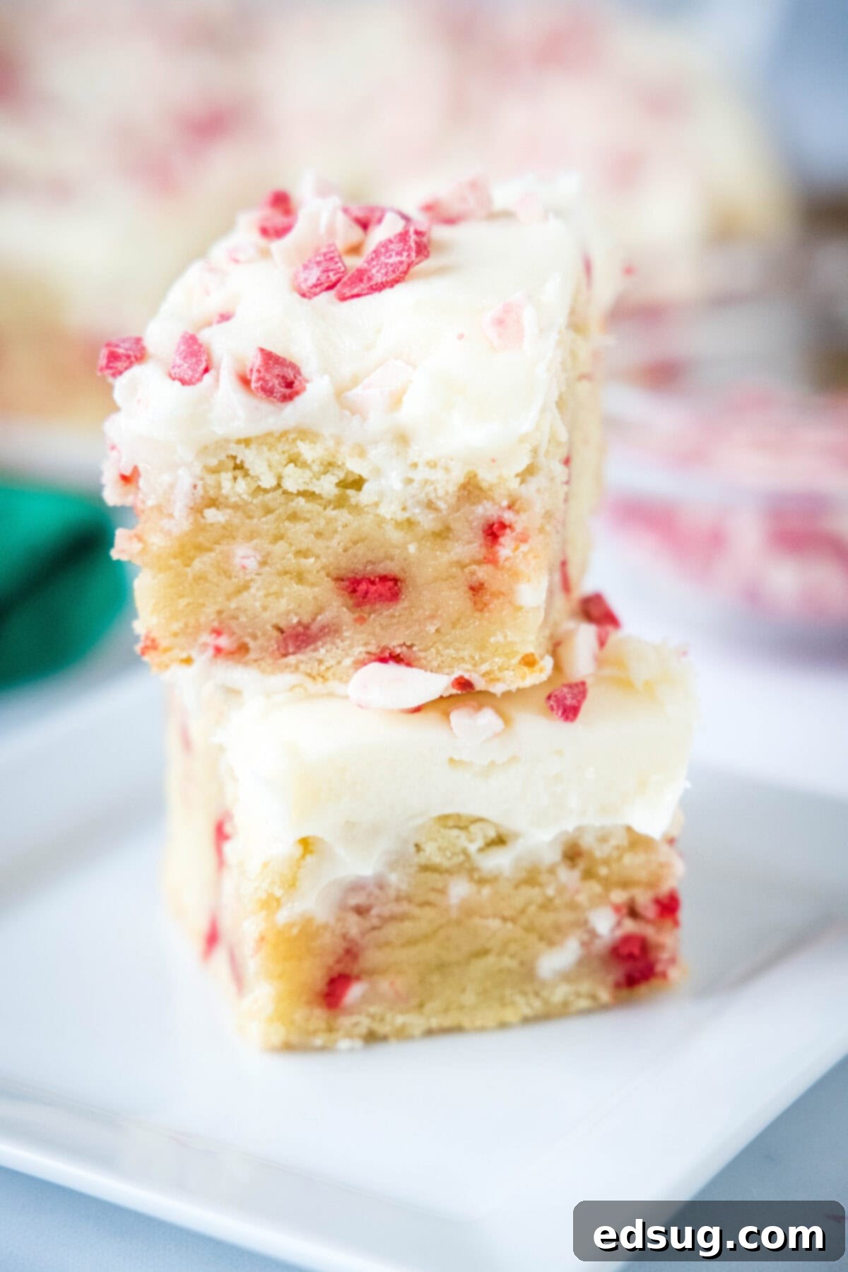 Holiday Peppermint Sugar Cookie Bars 2 stacked peppermint sugar cookie bars on a plate