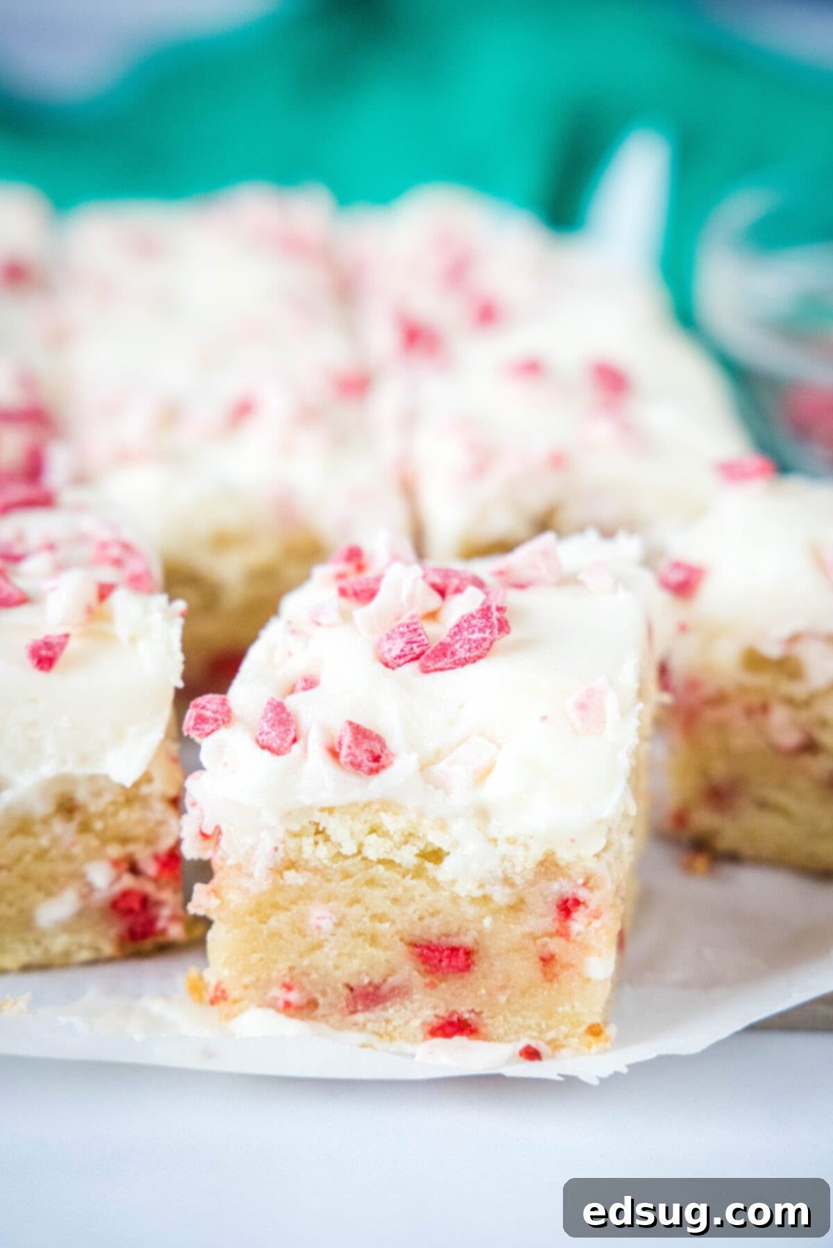 Holiday Peppermint Sugar Cookie Bars 6 sliced peppermint sugar cookie bars on a board